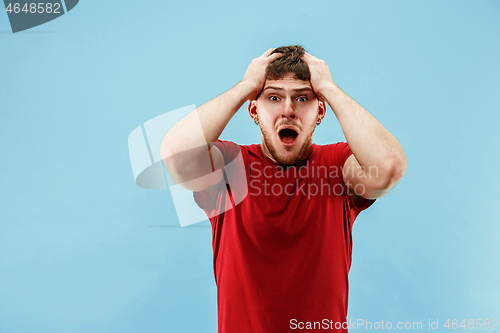 Image of Young boy with a surprised expression bet slip on blue background