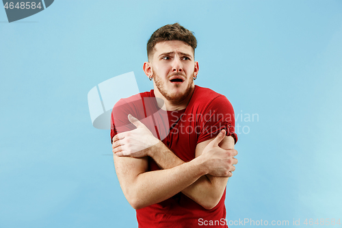 Image of Young boy with a surprised expression bet slip on blue background