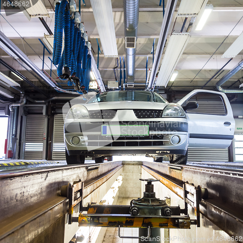 Image of Low angle view of small urban personal car at service station at car repair garage