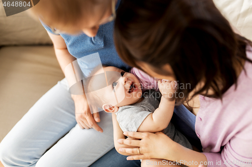 Image of happy mixed-race family with baby son at home