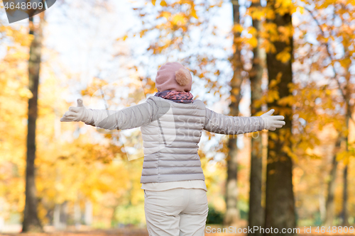 Image of happy woman enjoying beautiful autumn