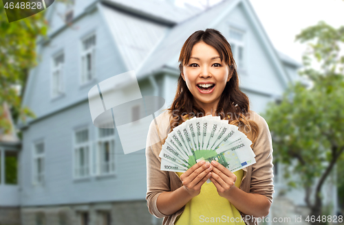 Image of asian woman with hundred euro money banknotes