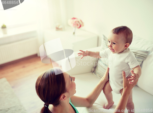 Image of happy young mother with little baby at home