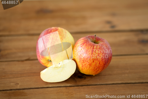 Image of ripe red apples on wooden table