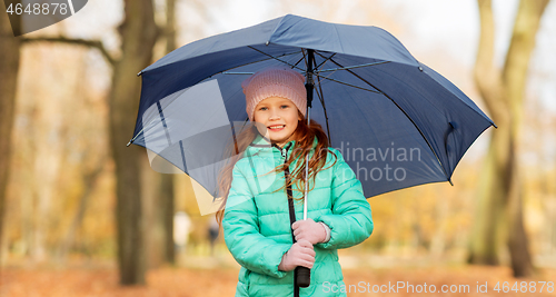 Image of happy little girl with umbrella at autumn park