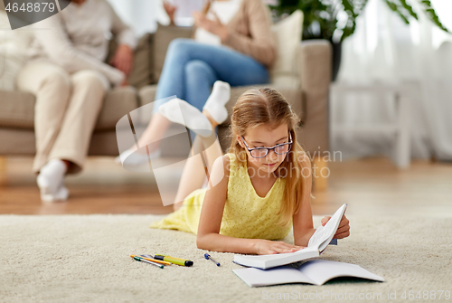 Image of student girl with textbook learning at home