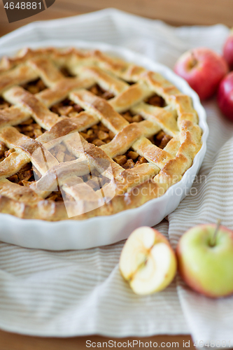 Image of close up of apple pie in baking mold on towel