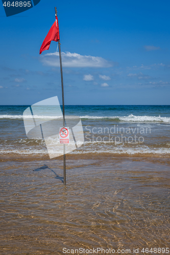 Image of Red flag on the beach. Swimming and surfing ban.