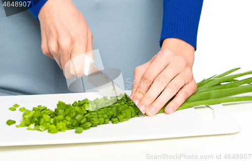 Image of Cook is chopping green onion