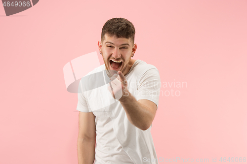 Image of The happy business man standing and smiling against pink background.