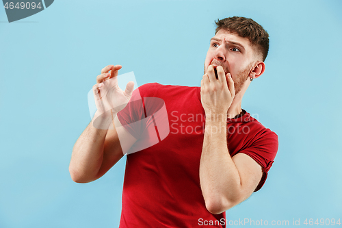 Image of Portrait of the scared man on blue