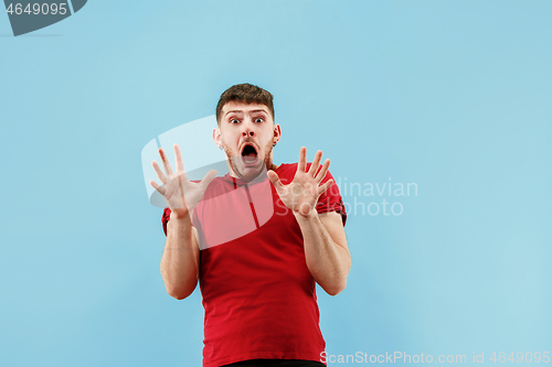 Image of Portrait of the scared man on blue