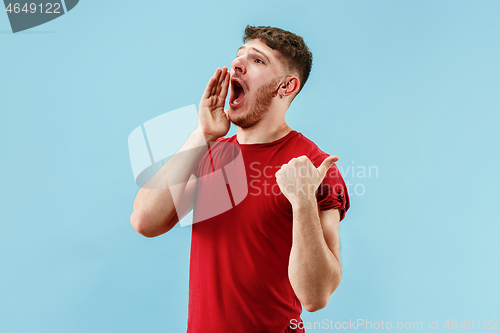 Image of Isolated on pink young casual man shouting at studio