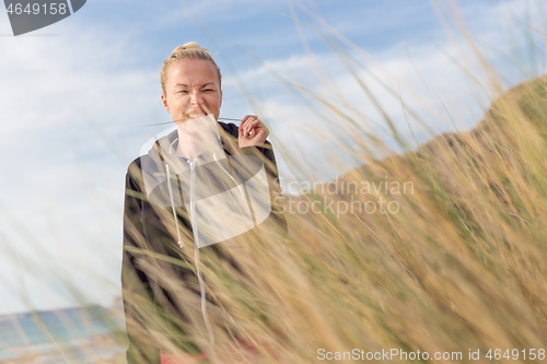 Image of Relaxed Happy Woman Enjoying Walk on Beach