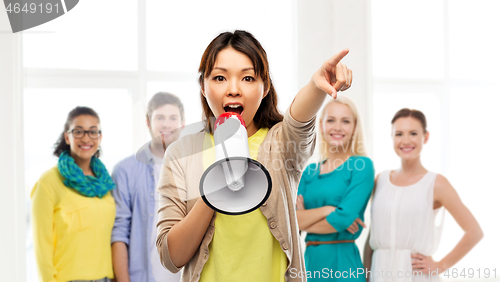 Image of asian woman with megaphone over group of people