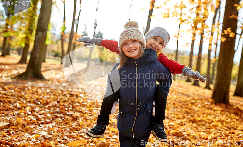 Image of happy children having fun at autumn park