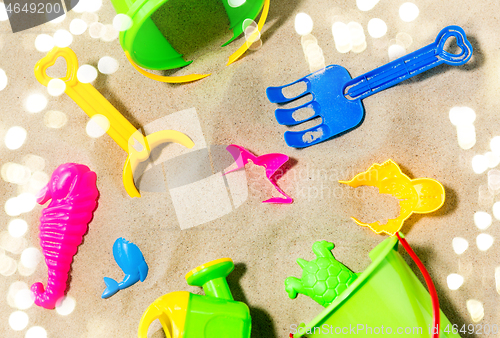 Image of close up of sand toys kit on summer beach