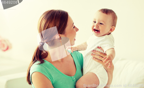 Image of happy young mother with little baby at home