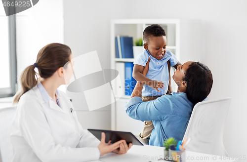 Image of mother with baby and doctor with tablet at clinic