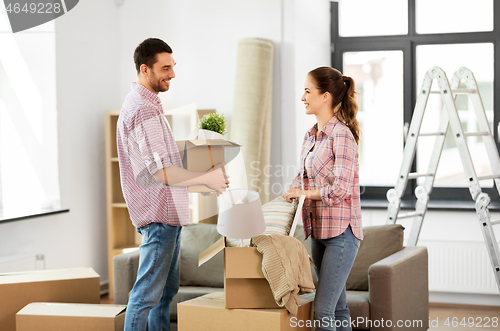 Image of happy couple with stuff moving to new home