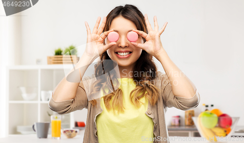 Image of happy asian woman with eyes of macarons