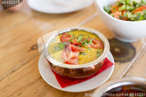 Image of close up of vegan tarka dal in bowl on table