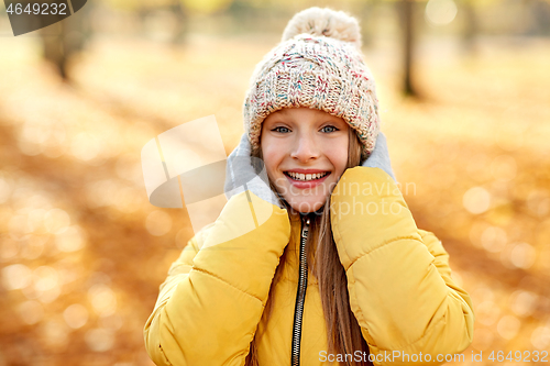 Image of portrait of happy girl at autumn park