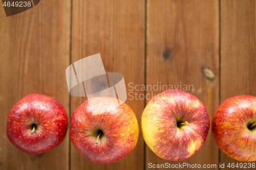 Image of ripe red apples on wooden table