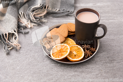 Image of hot chocolate with dried orange, cookies and anise