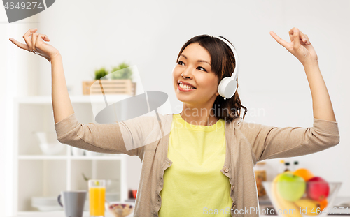 Image of asian woman in headphones listening to music