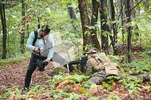 Image of Videographer Taking Action Shoot of Soldiers in Action