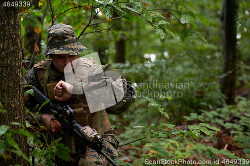 Image of soldier preparing tactical and commpunication gear for action ba