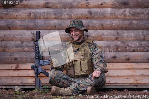 Image of soldier using tablet computer in military camp