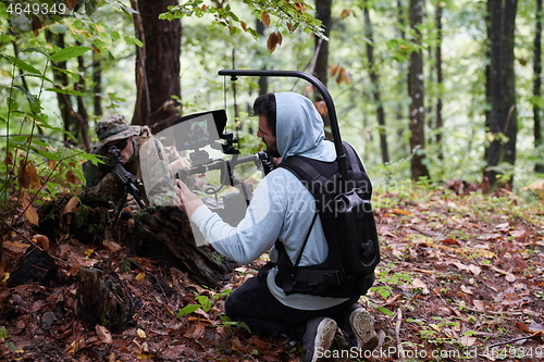 Image of Videographer Taking Action Shoot of Soldiers in Action