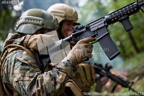 Image of military squad in action rescue wounded soldier