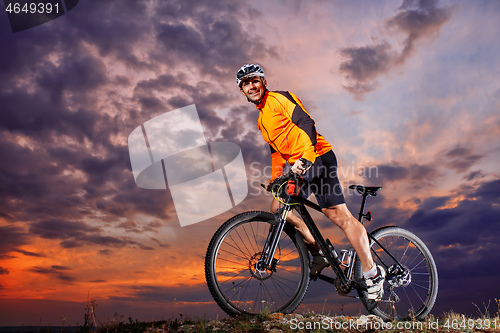 Image of Man in helmet and glasses stay on the bicycle