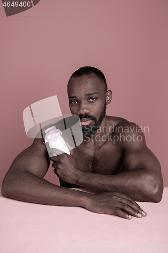 Image of Healthy young african man holging milk