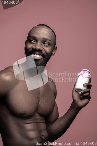 Image of Healthy young african man holging milk