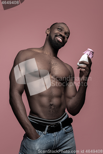 Image of Healthy young african man holging milk