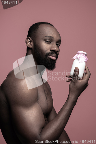 Image of Healthy young african man holging milk