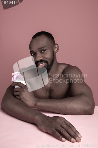 Image of Healthy young african man holging milk