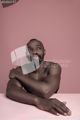 Image of Close up portrait of a young naked african man indoors