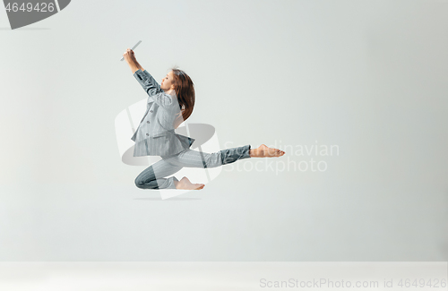 Image of Happy business woman dancing and smiling isolated over white.