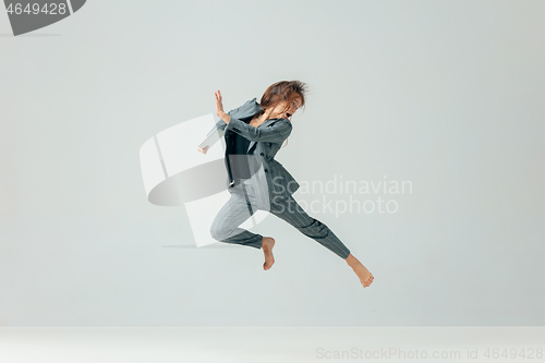 Image of Happy business woman dancing and smiling isolated over white.