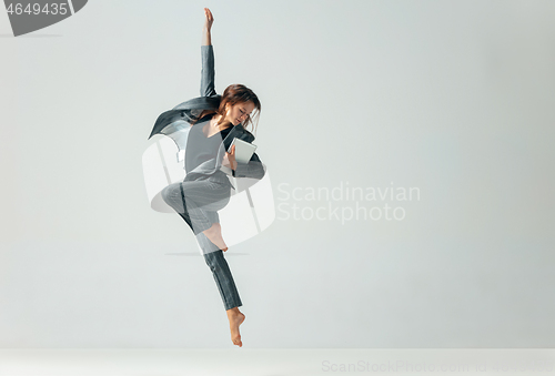 Image of Happy business woman dancing and smiling isolated over white.