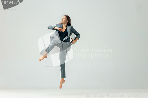 Image of Happy business woman dancing and smiling isolated over white.