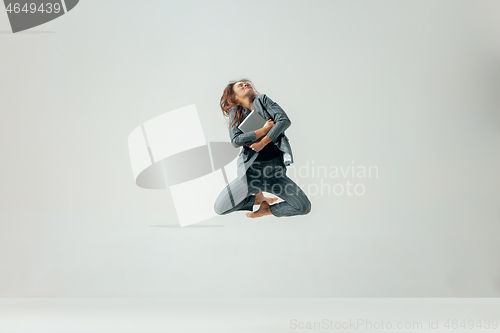 Image of Happy business woman dancing and smiling isolated over white.
