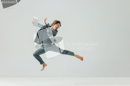 Image of Happy business woman dancing and smiling isolated over white.