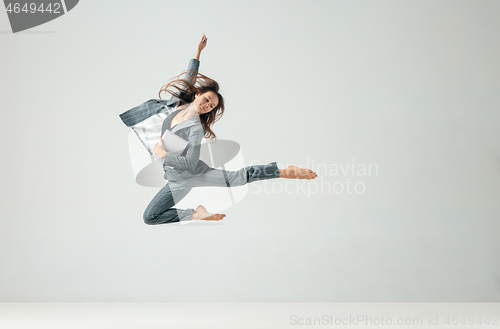 Image of Happy business woman dancing and smiling isolated over white.