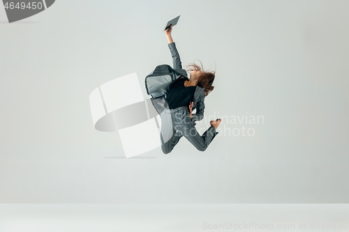 Image of Happy business woman dancing and smiling isolated over white.